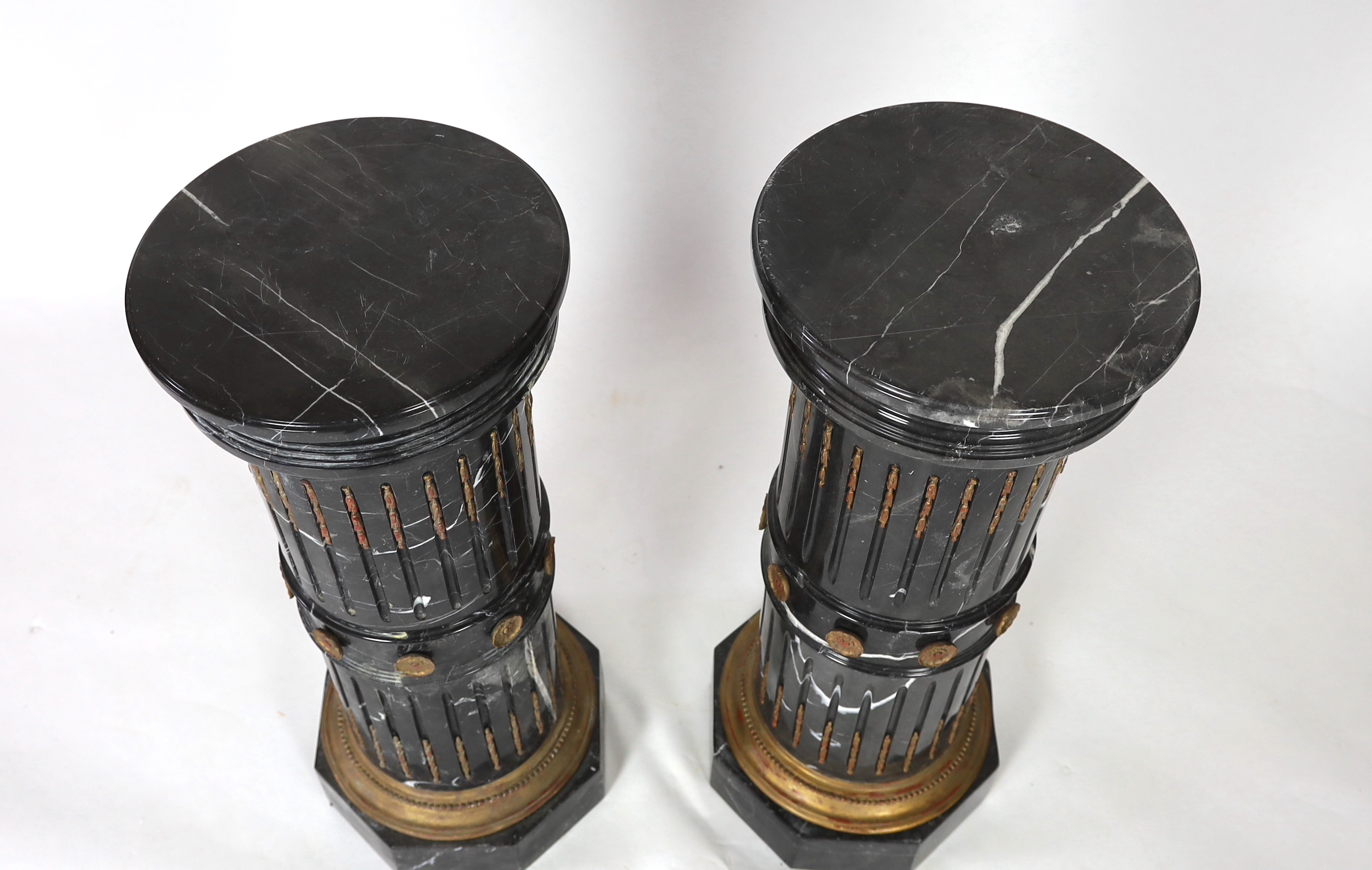 A pair of ornate variegated green marble columns, diameter 41cm, height 102cm